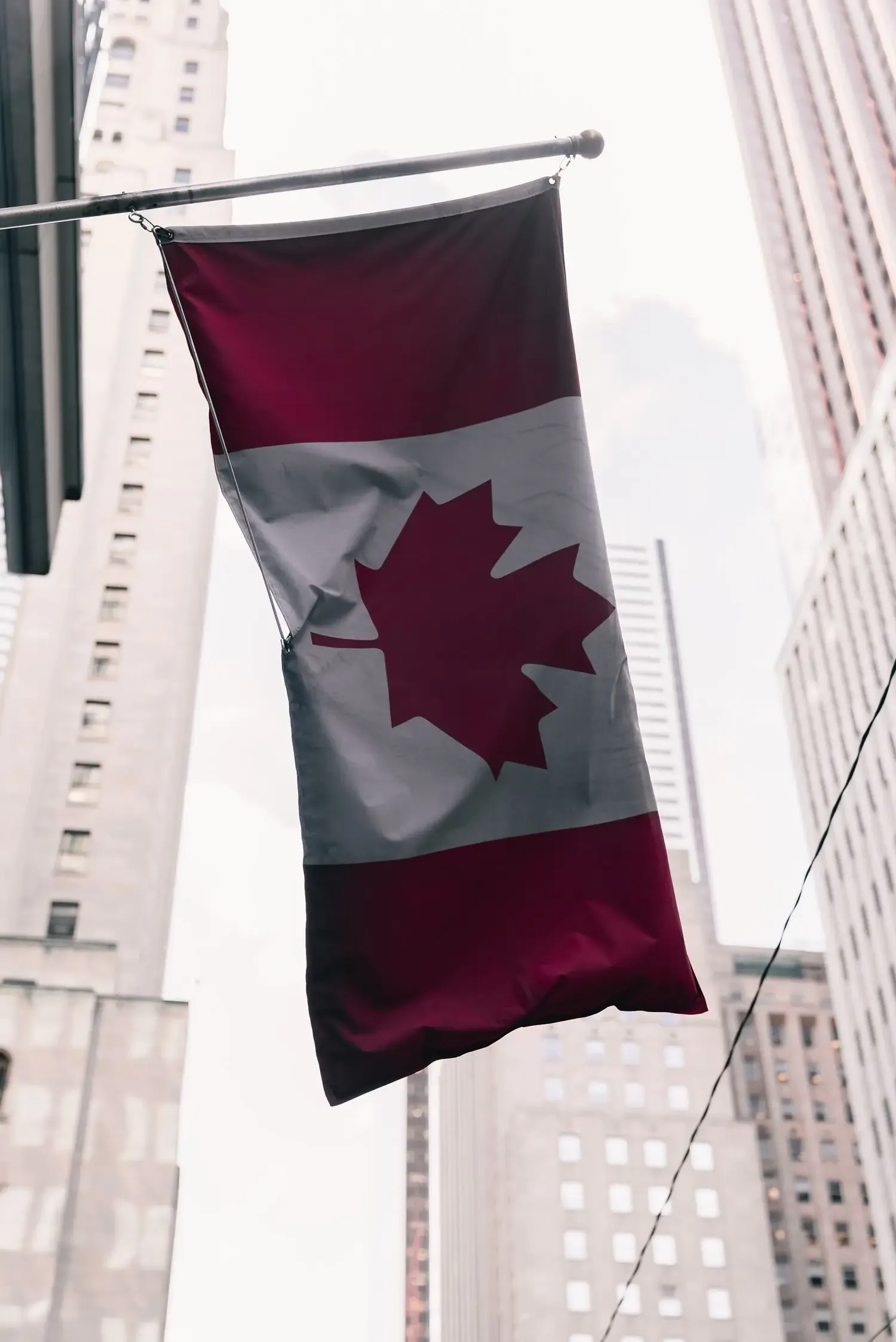 Canadian flag against an urban background
